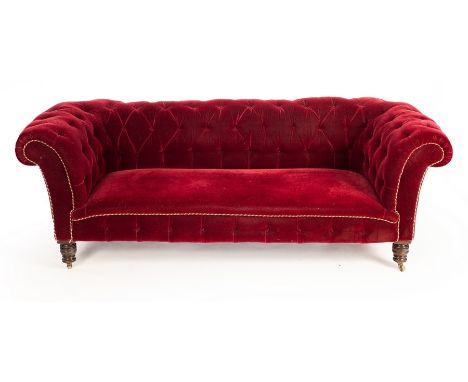 A Chesterfield sofa, the button back and arms upholstered in velvet, on turned legs with castors, approximately 200cm wide, 8