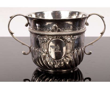 A George I silver porringer, Thomas Mason, London 1722, of twin-handled, half-ribbed form with a band of rope work decoration