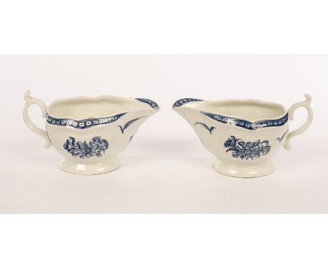 A pair of First Period Worcester blue and white moulded sauce boats, with double scroll handle and thumb rest, painted in the