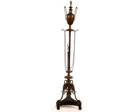 A bronzed metal standard lamp, modelled as an urn on a column with a tripod base, 172cm high excluding shade CONDITION REPORT