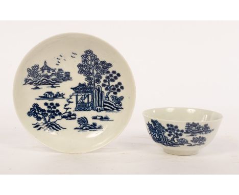 A large Worcester tea bowl and saucer in the blue and white pattern of 'The Man in the Pavilion' depicting a Chinese lake lan