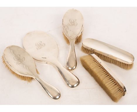 A silver backed dressing table set, Walker & Hall, Sheffield 1901, comprising a pair of hairbrushes and hand mirror, a closel