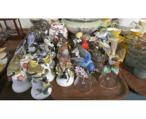 A Tray Containing Sixteen Glass and Ceramic Bells with Garden Bird Mounts 
