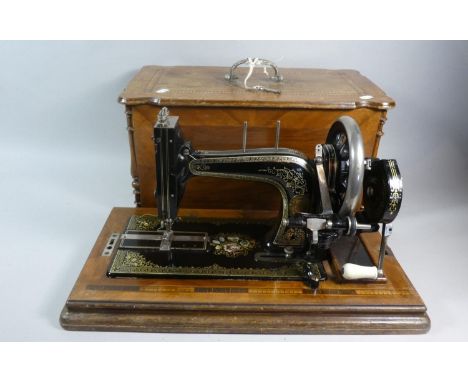 A Vintage Frister and Rossmann Sewing Machine in Inlaid Walnut Case 