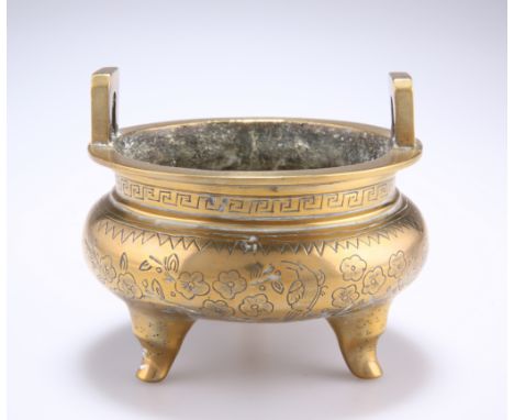 A CHINESE BRONZE CENSER, with tripod feet, decoration of flowerheads and birds, bears cast seal mark. 11.5cm diameter