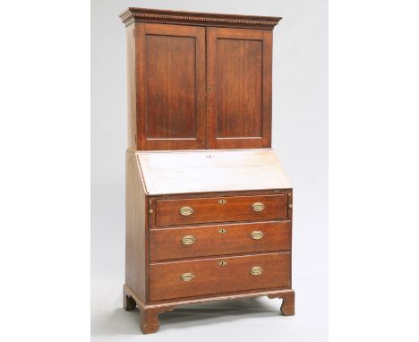 A GEORGE II OAK BUREAU&nbsp;BOOKCASE,&nbsp;the upper section with projecting dentil cornice above a pair of panel doors, the 