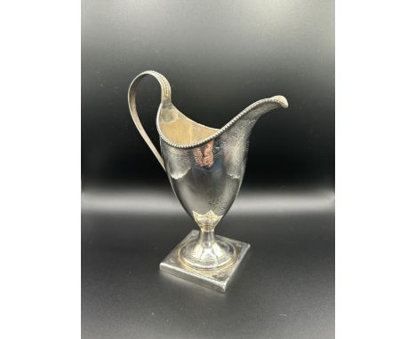 A George III silver jug, with bright cut decoration,&nbsp;crested, London 1789, 2.3 ozt, 13 cm high