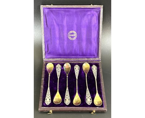 A set of six Continental silver coloured metal spoons, with gilt bowls and filigree handles,&nbsp;cased