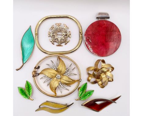 A pair of green enamel clip on earrings, in the form of leaves, three similar brooches, two gilt metal brooches, two rolled g