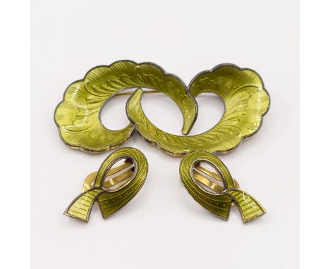 A 1970s silver and green enamel brooch, and a similar pair of earrings (2)