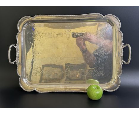A George VI silver twin handled tray, with engraved decoration of flowers and foliage, Sheffield 1937, 112.5 ozt, 63 cm wide