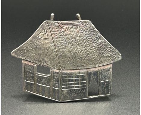 A Chinese silver coloured metal menu holder, in the form of a house, 18.7 g, 4.5 cm high