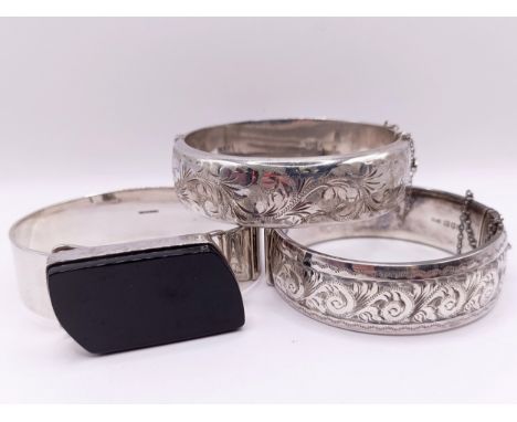 A silver and jet bangle, and two other silver bangles (3)