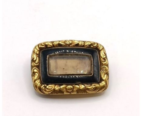 A 19th century yellow metal and black enamel memorial brooch Provenance:  Sold on behalf of Dorset Wildlife Trust23 mm wide