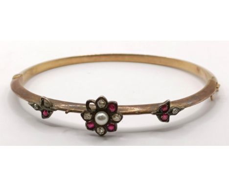 A pearl and red and white stone bangle Provenance:  Sold on behalf of Dorset Wildlife Trust6.1 g (all in)two stones missing, 