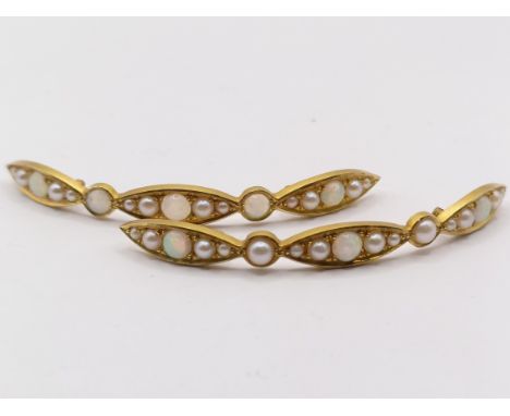 A pair of yellow metal, seed pearl and opal mounts, 60 mm wide (2)Testing as higher than 9ctweight: 8.6 g all inlargest opal:
