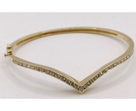 An 18ct gold and diamond wishbone bangle, 11.6 g (all in)