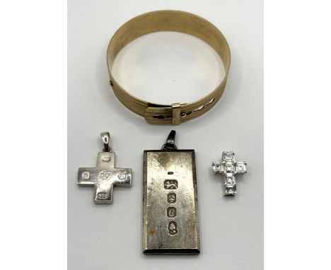 A modern silver cross pendant, London 2000, a silver ingot pendant, London 1977, 2.2 ozt, a gold plated bangle, and a paste s