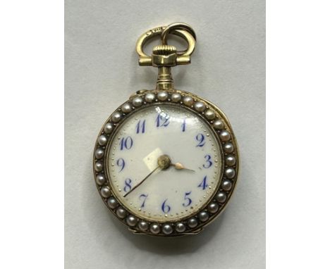A late 19th/early 20th century ladies Continental yellow coloured metal, green enamel, pearl and diamond fob watch, 2 cm diam