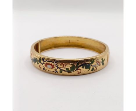 A gold and enamel bangleTesting as gold