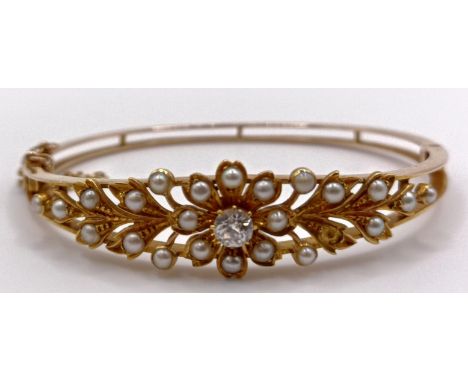 A 15ct gold, seed pearl and diamond bangle, 14.9 g (all in)