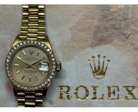 A ladies 18ct gold Rolex Oyster Perpetual Datejust Superlative Chronometer wristwatch, with a diamond bezel, with an outer bo
