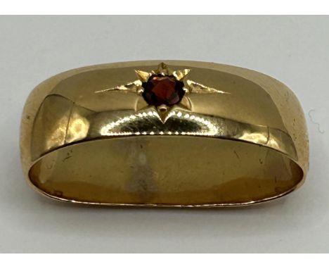 A yellow metal and garnet scarf ring, untested, 9.9 g (all in)No obvious part to acid test without damaging