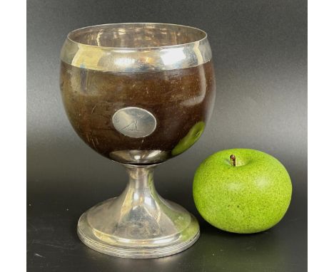A George III Scottish coconut cup, crested, on silver pedestal base, P Cunningham & Son, Edinburgh 1810, 16 cm highCoconut ha