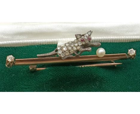 An early 20th century yellow metal, diamond and pearl stick pin, in the form of a cat playing with a ball Provenance:  Sold o