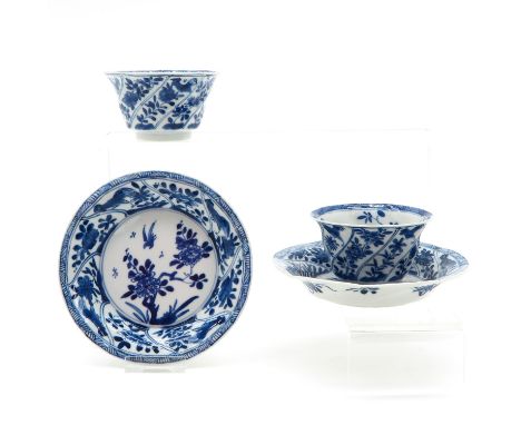 Depicting flowers, marked on bottom with double ring, saucers are 13 cm. in diameter. 