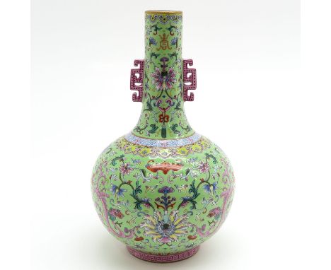 Light green ground with Famille Rose enamels depicting flowers, marked on bottom with seal mark, 31 cm. tall.