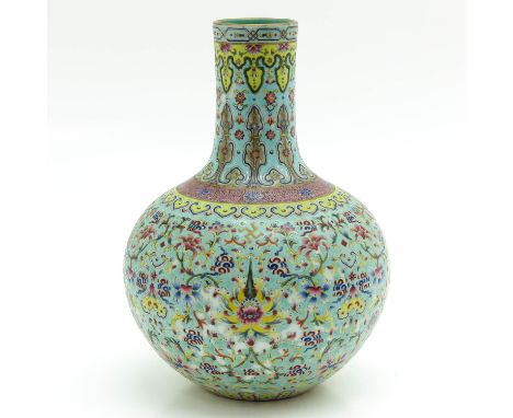 Depicting flowers, light blue ground with Famille Rose enamels, marked on bottom with seal mark, 31 cm. tall.