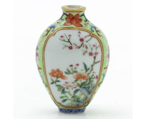 Light green ground with Famille Rose enamels depicting flowers, marked with seal mark on the bottom, 7 cm. tall, missing top.
