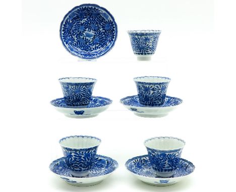 Depicting flowers, marked on bottom with double ring and 6 characters, saucers are 13 cm. in diameter, hairline.