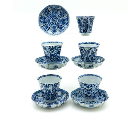 Depicting flowers, saucers are 13 cm. in diameter, hairline.
