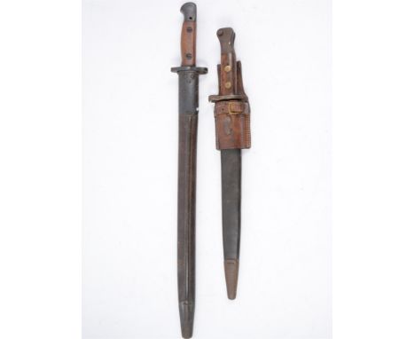 Two Bayonets, one marked Wilkinson 1907 with two piece wooden grip in a steel mounted leather sheath 57cm, another later bayo