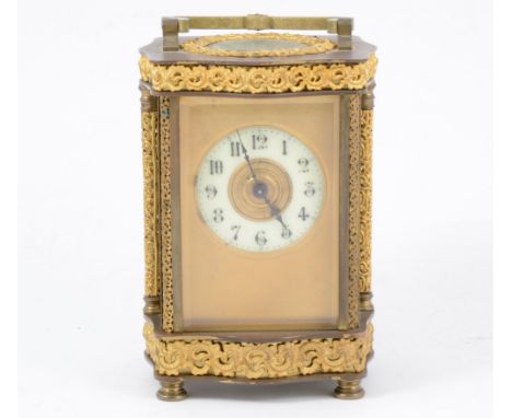 French brass carriage clock, the case with serpentine outlines, cast decoration ivorine chapter ring platform escapement,14cm