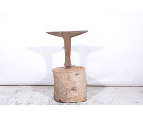 Stake anvil, head length 42cm, stood in a silver birch trunk.