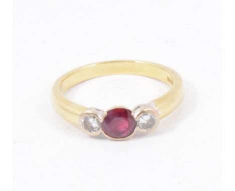 A ruby and diamond three stone ring, a circular ruby and two brilliant cut diamonds collet set in an 18 carat yellow and whit