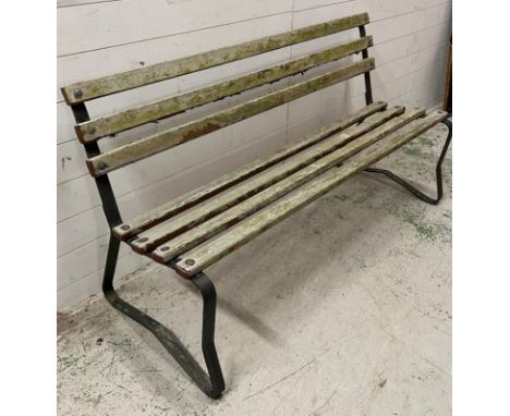 A wooden slatted garden bench on metal legs (H84cm W155cm D60cm)