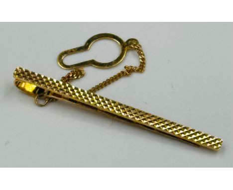 A 9ct yellow gold diamond cut tie pin on safety chain with an approximate total weight of 2.6g