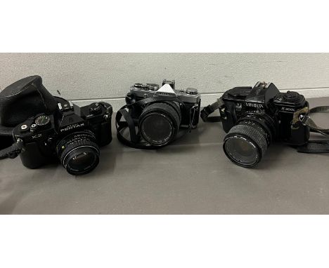 Three cameras, Minolta, Pentax and Olympus 