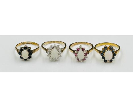 A selection of four opal themed rings in daisy styles all in 9ct yellow gold settings, approximate total weight 9.7g 