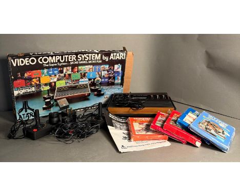 An Atari Video Computer System with games, manual, controllers etc.