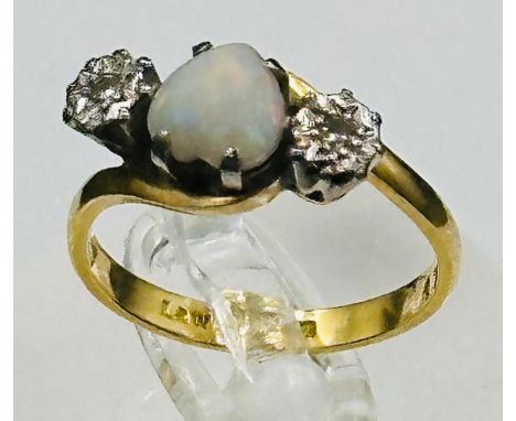 An opal and diamond ring. centre heart shaped opal with diamond shoulders on an 18ct yellow gold setting. approximate weight 