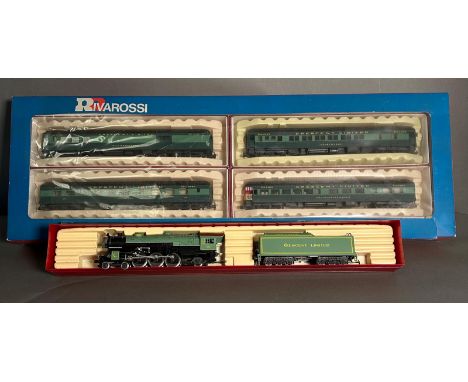 A boxed Rivarossi steam engine and coal car and a box of four Rivarossi trains 