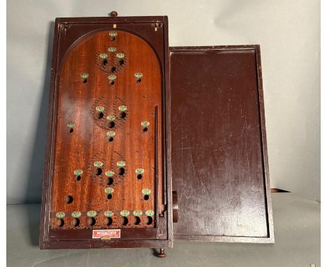 A Corinthian vintage Bagatelle game with lid and balls