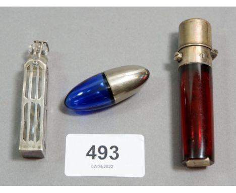 A sterling silver overlaid glass scent bottle, a ruby glass one chipped and a blue glass and silver plated torpedo shaped one