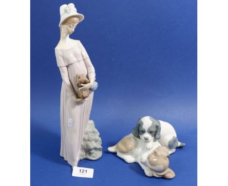 A Lladro figure of a woman with puppy and a Lladro Nao group of two puppies 