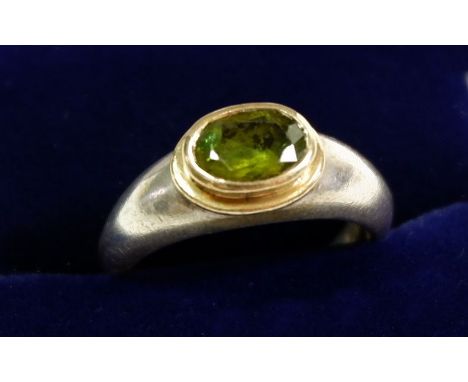 A silver peridot set studio jewellery ring, size K to L 